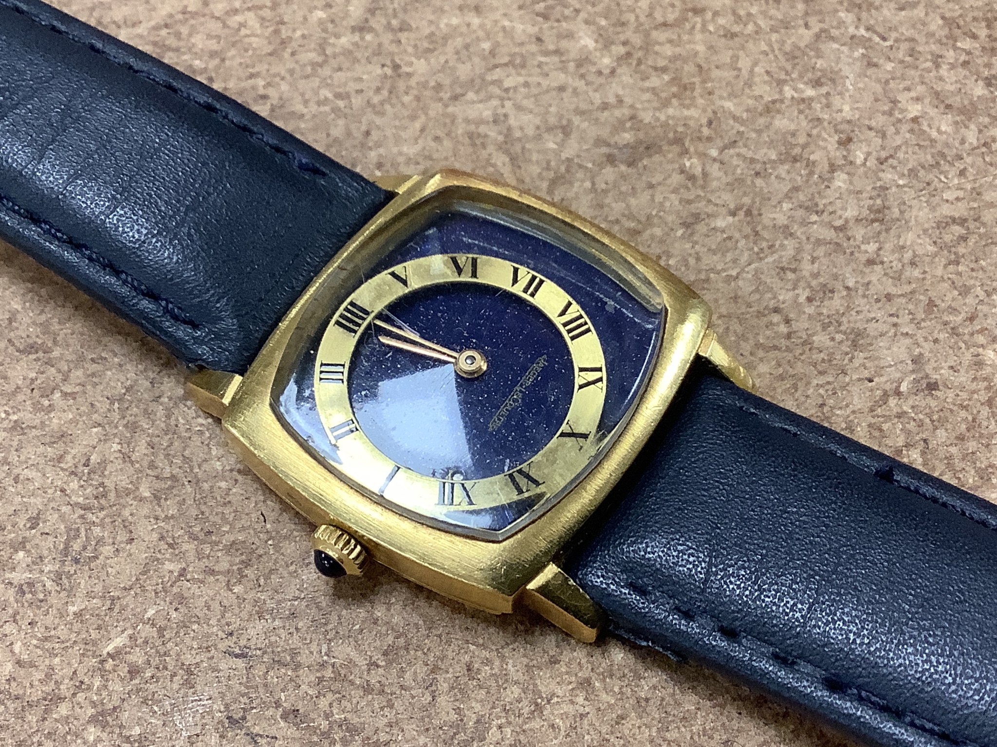 A lady's? 18k yellow metal Jaeger LeCoultre manual wind dress wrist watch with lapis lazuli dial (with loose Roman chapter ring), case diameter 29mm, gross weight29.7 grams.